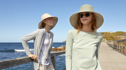 Two women wearing sun smart clothing and sun hats